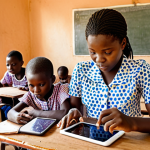 **

A classroom in Burkina Faso, children using tablets for learning, teacher assisting, bright and colourful atmosphere, modern technology integration, promoting digital literacy, focus on engaged students.

**